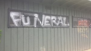 Graffiti on closed business, surrounded by new development construction 